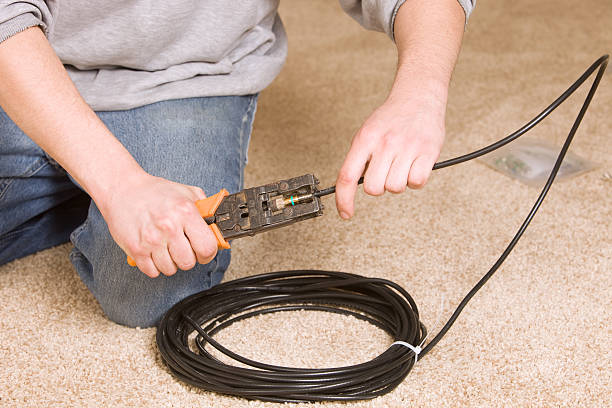 AV Technician Compressing an RCA Connector to Coax Cable