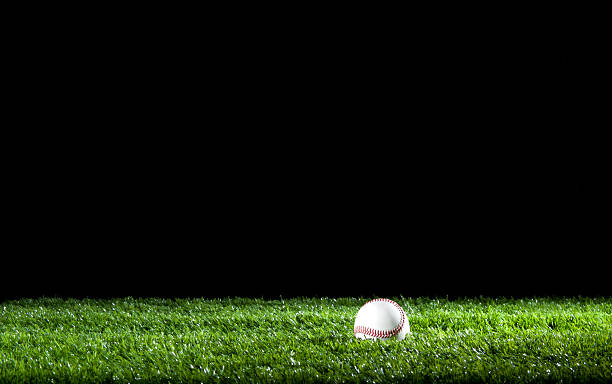 Baseball in the grass at night