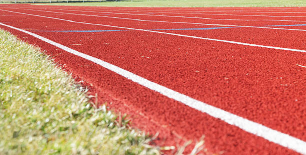 istock Off Season Running Track Messy with Grass and Debris 183796401