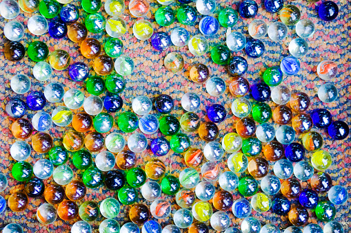 Many multi colored  glassy marbles