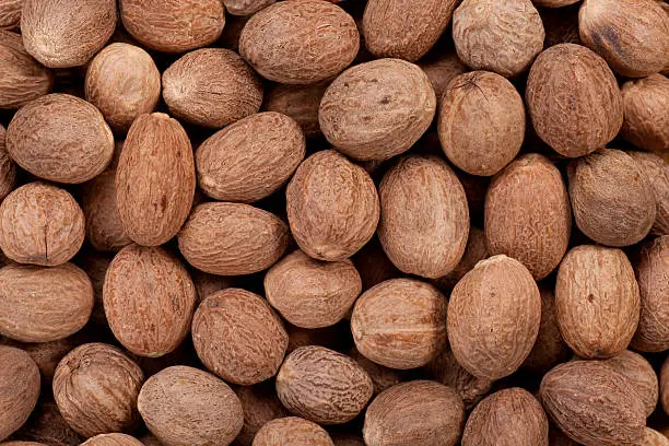 Close up of whole nutmegs as a background.Full Frame.
