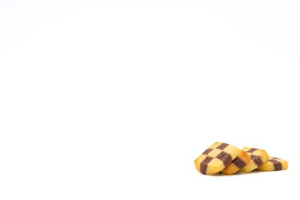 Christmas cookies isolated on a white background. Black and white cookies with a checkerboard pattern are a type of cookie made from shortcrust pastry in which one part of the dough contains cocoa.
