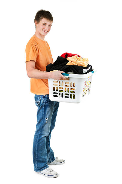 teenager boy transporte con cesta de la ropa sucia de ropa sobre blanco - isolated on white full length lifestyles yellow fotografías e imágenes de stock