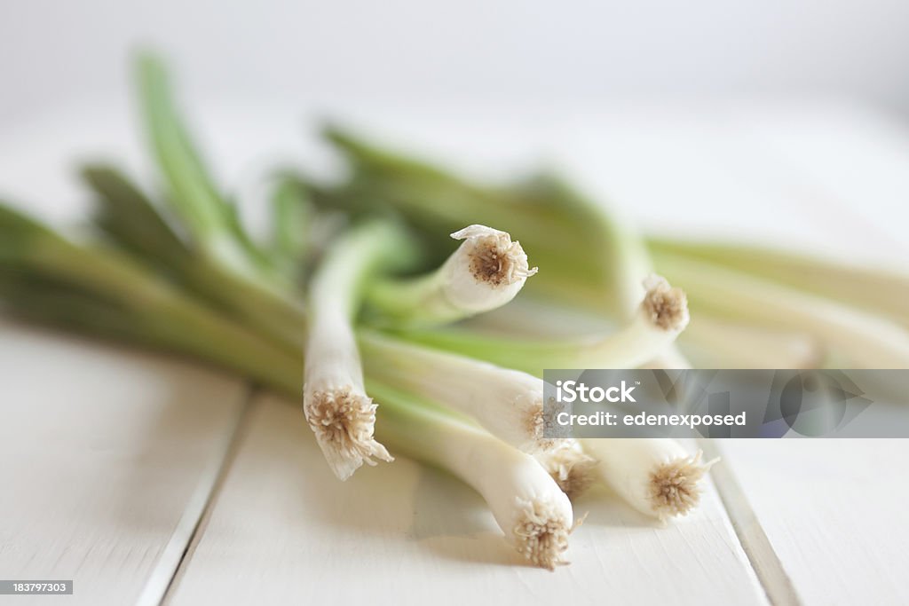 Spring Onion Spring onions on a wooden table.  Food Stock Photo