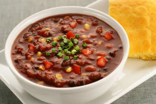 Bowl of healthy vegan chili with cornbread.