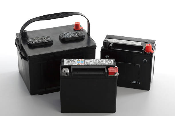 Vehicle Batteries "New car, motorcycle, and lawn tractor batteries with protective red/black plastic caps ready for installation" car battery stock pictures, royalty-free photos & images