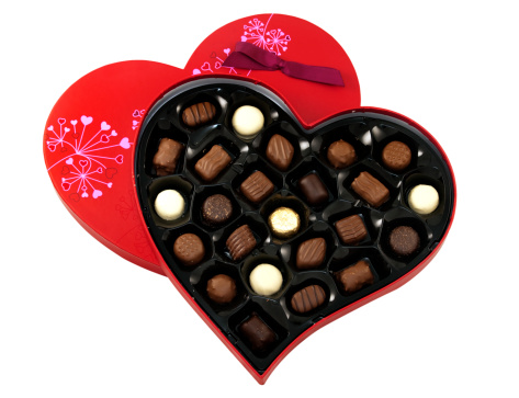 Heart shaped box of chocolates on white