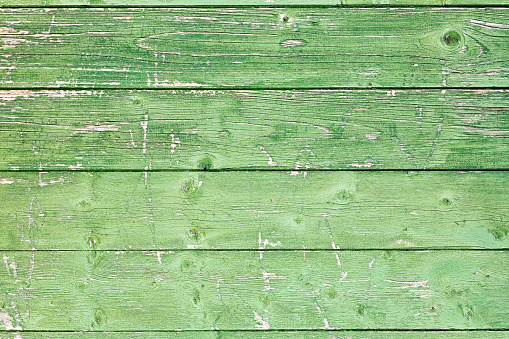 Distressed green paintwork on horizontal wooden panels. There are companion images: