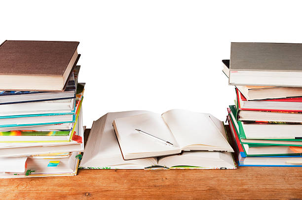 istock Books and notebook lying on desk between stacks of books 183798375