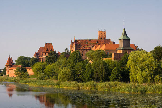 Malbork castle, Poland "Malbork castle in dusk. The bigest medieval castle from bricks in Europe. Capitol of the Teutonic Order - Crusaders, PolandSee more CASTLE AND PALACE images here:" malbork photos stock pictures, royalty-free photos & images