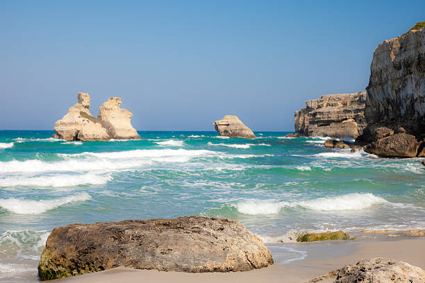 Torre dell'Orso (Apulia, Italy) Torre dell'Orso (Apulia, Italy) beach, a wide sandy cove enclosed torre dellorso stock pictures, royalty-free photos & images