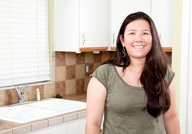 istock Smiling Asian Woman in the Kitchen 183799029