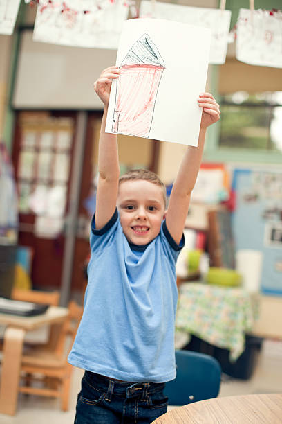 istock Boy Student Showing Picture at School 183799237