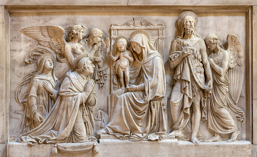 Genova - The marbel relief of Madonna with the saints and angels in the church Basilica della Santissima Annunziata del Vastato by Santo Varni (1807 - 1885).