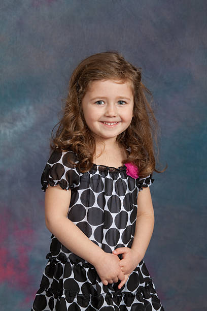 Young Girl School / Yearbook Portrait Age 4 Almost 5 Portrait of a four-year-old  (almost 5) girl with against a studio background.  Model  has blue eyes and has a happy smile.See other related images here: school picture stock pictures, royalty-free photos & images