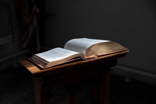 istock Bible on A Dark Background. Selective focus. Shallow Depth of Field 1837997923