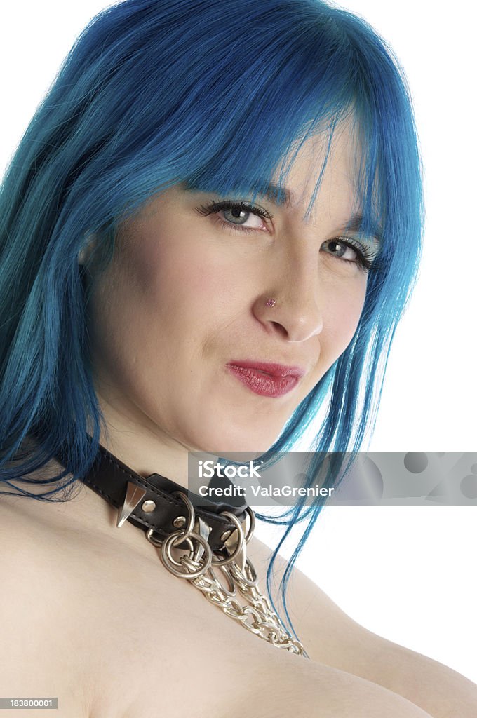 Blue haired model smirking in collar. Beautiful naked model wearing interesting collar.  Vertical studio shot on white. 20-29 Years Stock Photo