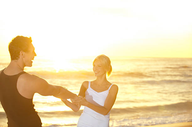 istock Couple twirling on the beach 183800137