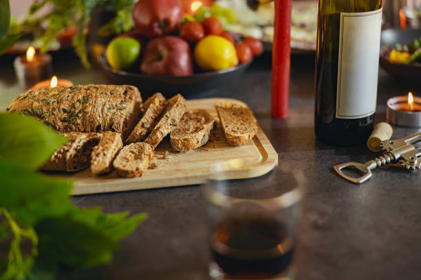 Healthy multi grain cut bread with seeds on a wooden board is standing on festive table