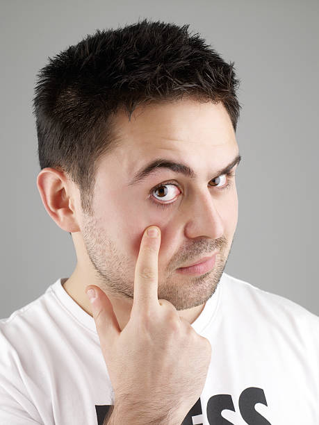 istock A man making a funny facial expression with his hand 183800219