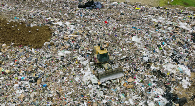 Aerial View of Bulldozer Pushing Garbage in a Landfill in Ottawa County, Ohio on Overcast Day