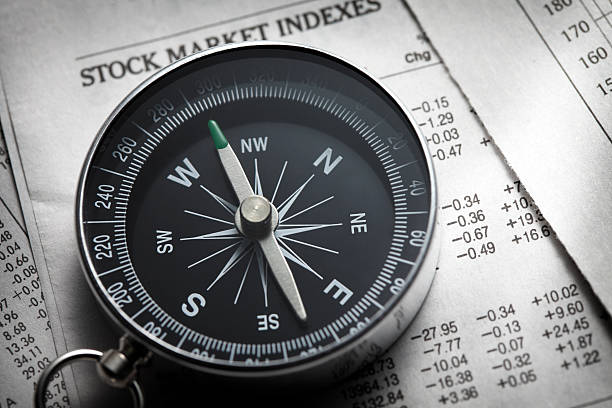istock Compass On Top Of Stock Market Data From Newspaper 183800330