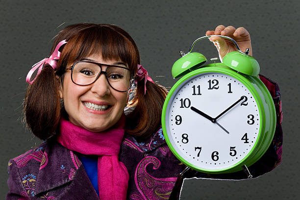 istock Smiling nerd woman holding alarm clock 183800334