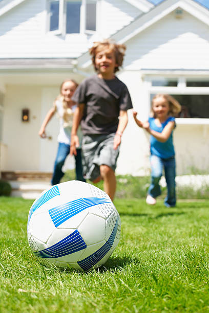 istock Kids playing soccer in the backyard 183800520