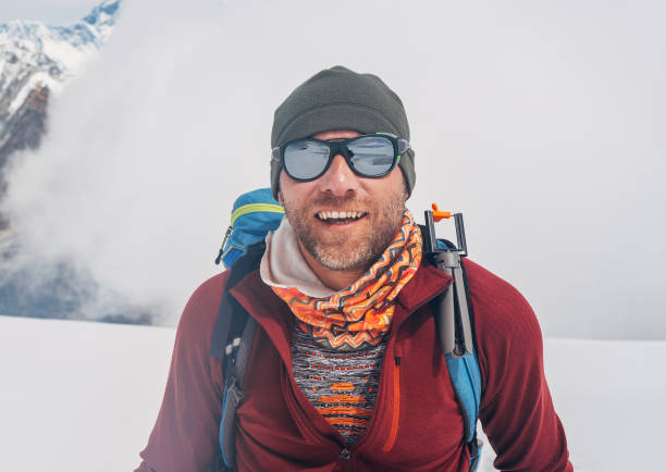 istock Cheerful laughing climber in sunglasses portrait with backpack ascending Mera peak high slopes at 6000m enjoying beautiful sunny weather, physical challenge in High Himalayas. North-Eastern Nepal. 1838005425