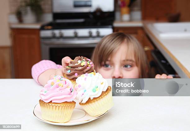 Little Girl Sneaking Cupcake Stock Photo - Download Image Now - Child, Tiptoe, Peeking