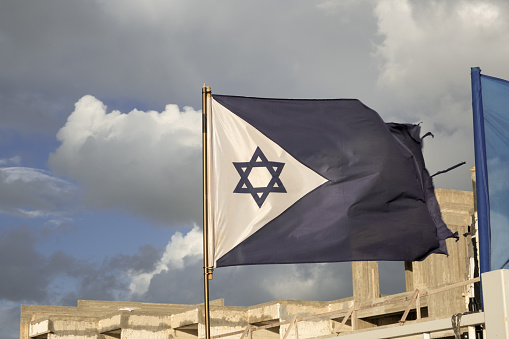 Israel flag of Navy military sea force, the Star of David on, proudly waves in the wind, symbolizing strength and national pride.