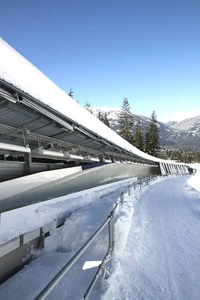 "The Olympic sliding track, covered in snow, in Whistler British Columbia. The track can be used for bobsleigh, luge, and skeleton events."