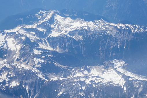 Minutes after taking off at SeaTac Airport the plane leave the coastline to cross the Rocky Mountains