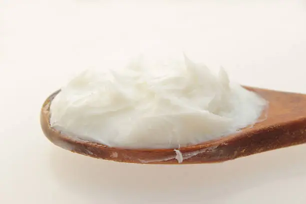 "refined ghanaian shea butter isolated on whiteShea butter is a slightly yellowish or ivory colored natural fat extracted from the seed of the African shea tree by crushing and boiling. It is widely used in cosmetics as a moisturizer and salve. Shea butter is edible and may be used in food preparation, or sometimes in the chocolate  industry as a substitute for cocoa butter."
