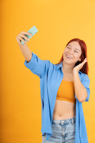 istock Young woman taking a selfie with her cell phone 1838020967