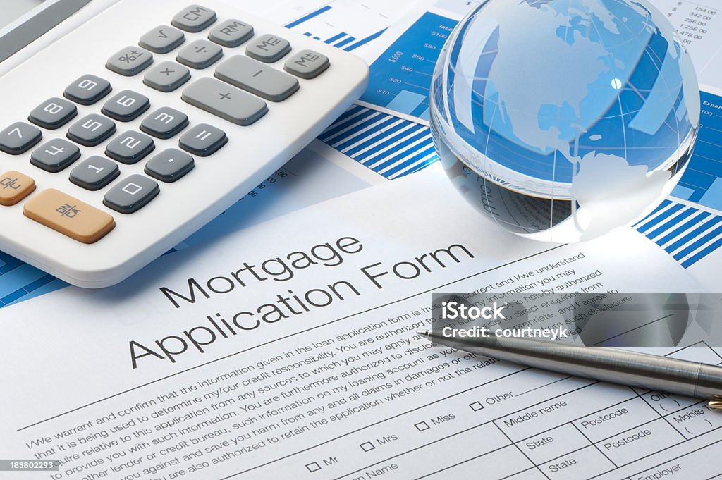 Mortgage application form "Mortgage application form with a calculator, pen and globe" Agreement Stock Photo