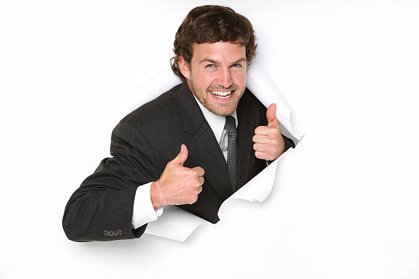istock Businessman emerging through a hole showing thumbs up sign 183802616