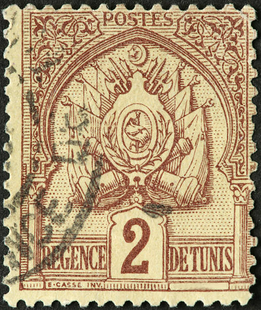 istock Tunisian flags, shield, and cannons on a postage stamp 183802863