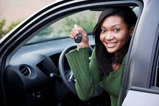 istock Young driver holding up car key 183803982