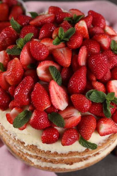 istock Tasty cake with fresh strawberries and mint on table, above view 1838041240