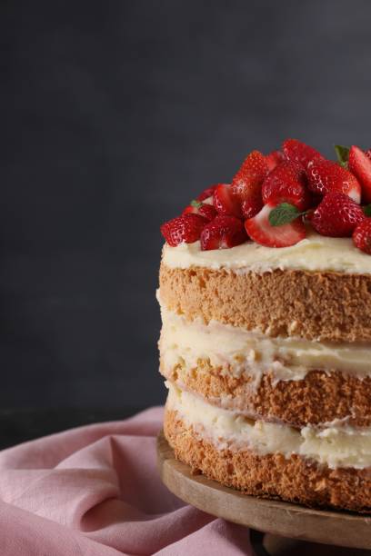 istock Tasty cake with fresh strawberries and mint on table against dark gray background 1838041325