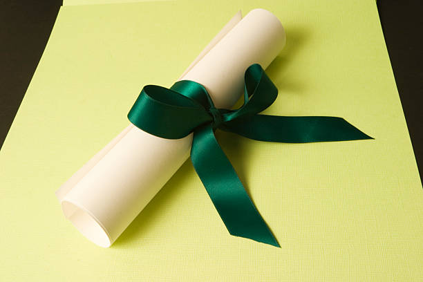 Rolled Paper & Ribbon on yellow stock photo