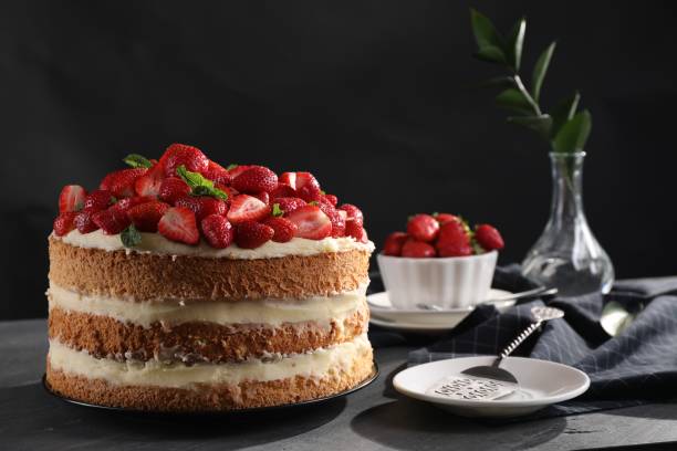 istock Tasty cake with fresh strawberries and mint served on gray table 1838042307