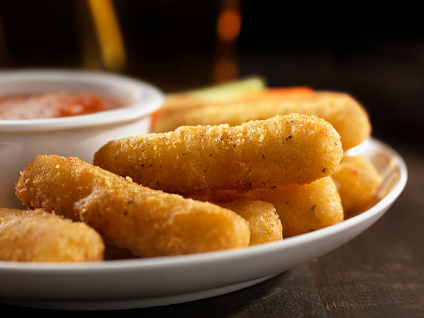 Crispy Mozzarella Sticks Crispy Mozzarella Sticks with a Marinara Dipping Sauce and a Beer -Photographed on Hasselblad H3D-39mb Camera Mozzarella Sticks stock pictures, royalty-free photos & images