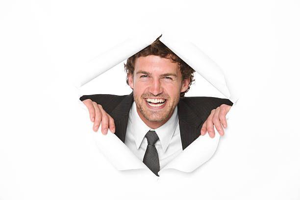 istock Businessman looking through a hole in white paper 183804295