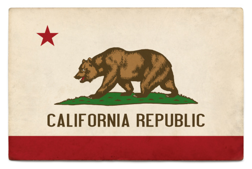 Flag of California layered on grungy, postcard-sized old paper with added vintage effects.