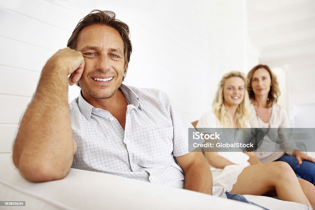 Homem maduro sentado em um sofá com a família - Royalty-free 20-29 Anos Foto de stock