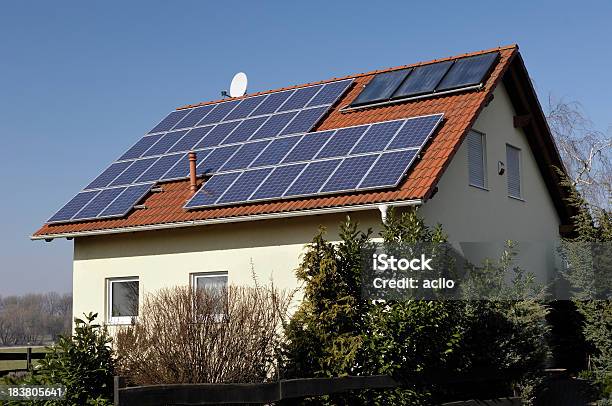Yellow Single Family House With Solar Panels On The Roof Stock Photo - Download Image Now