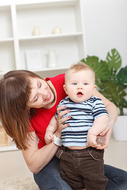 istock Young woman holding baby boy 183806207