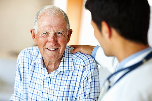 istock Doctor comforting senior man 183806415
